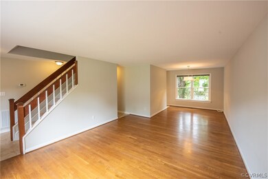Nice living room with hardwood floors adjoins dini