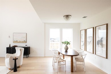 Dining area with light wood-style floors and base