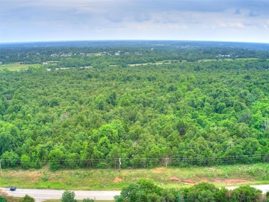 Drone / aerial view featuring a wooded view