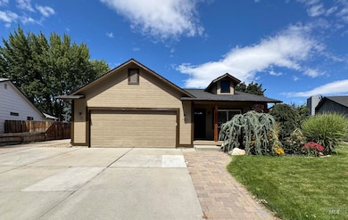 Single story home with concrete driveway and a garage