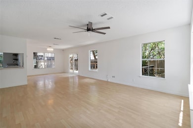Unfurnished living room with ceiling fan, light w