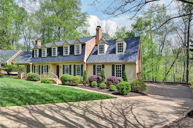 Cape cod-style house with a front yard and a chimn