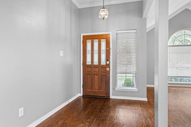Foyer with dark hardwood / wood-style floors and o