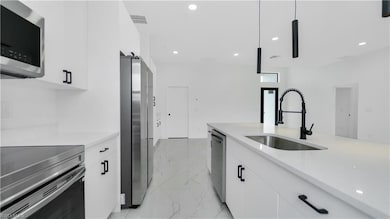 Kitchen featuring a sink, appliances with stainles