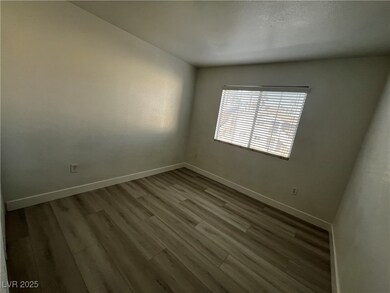 Empty room featuring baseboards and wood finished
