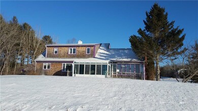 Back of home with Sunroom.