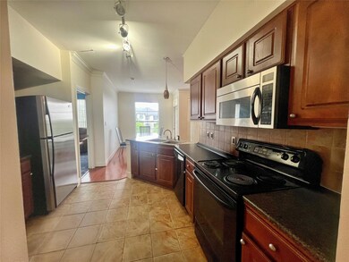 Kitchen with black appliances, a peninsula, crown