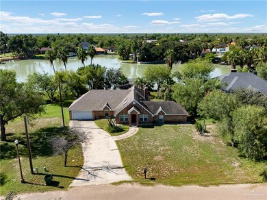 View from above of property featuring a nearby body of water and a tree filled landscape
