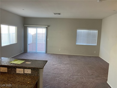 Carpeted empty room featuring baseboards