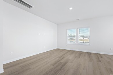 Spare room featuring light hardwood / wood-style f