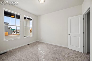 Empty room featuring light carpet