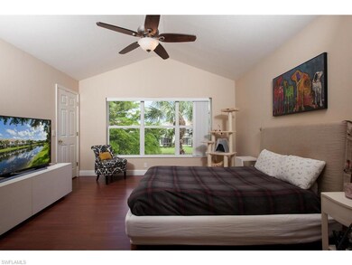 Master bedroom easily fits a king bed. View of the pond. Wood flooring. En suite bathroom with dual vanities.