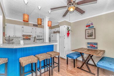 Kitchen featuring white appliances, a peninsula, w