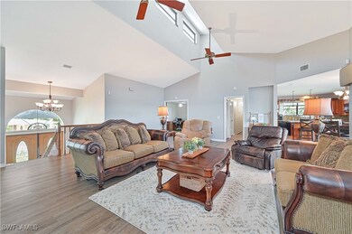 Living room featuring ceiling fan with notable cha