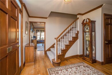 Formal Foyer boasts crown molding, curved staircas