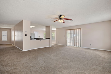 Unfurnished living room featuring ceiling fan, da