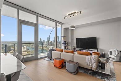 Living area with rail lighting, expansive windows