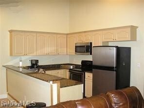 Kitchen with stainless steel appliances, dark coun