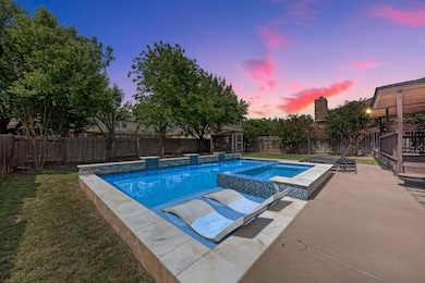 Pool at dusk featuring a patio and a pool with co