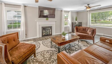 Living room with crown molding, gas fireplace, and
