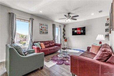 Living room featuring ceiling fan, hardwood / wood-style floors, and a wealth of natural light