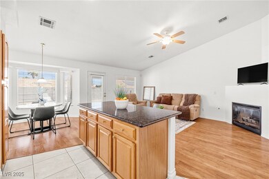 Kitchen featuring lofted ceiling, ceiling fan, dar