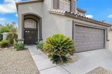 Property entrance with a tiled roof, stucco siding, and a garage