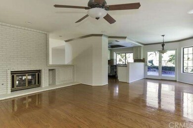 Warm hardwood floors flow through the family room 
