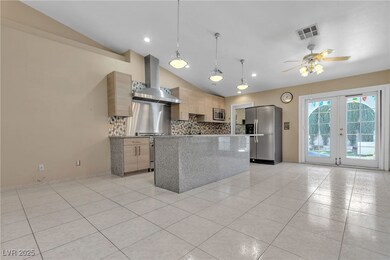 Kitchen with tasteful backsplash, vaulted ceiling,