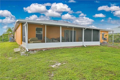 Rear view of house featuring a sunroom