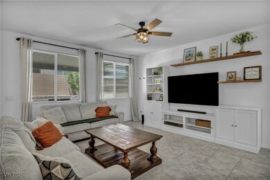 Living room with a ceiling fan, light tile pattern