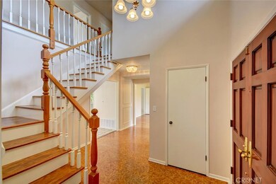 Formal entry with classic staircase and half bath nearby