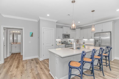 Kitchen with a kitchen island with sink, visible v