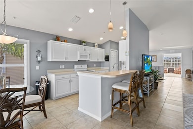This useful island features plenty of countertop space for food prep and casual dining.