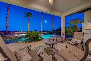 Patio at twilight featuring an in-ground hot tub,
