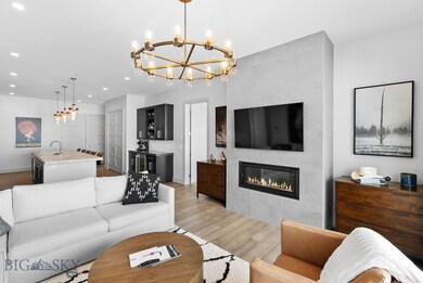 Custom tiled gas fireplace leads to open kitchen