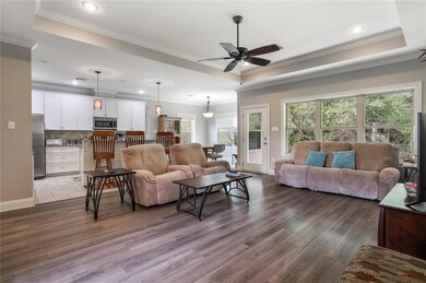 Open floor plan with wall of windows overlooking r
