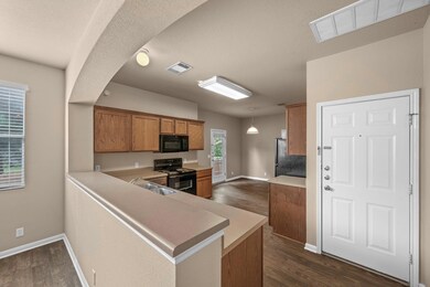 Kitchen with dark wood-style floors, a sink, visi