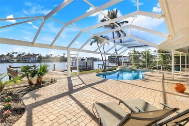 View of pool with a lanai, a water view, a patio, 