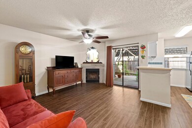 Living area featuring a fireplace, baseboards, ce