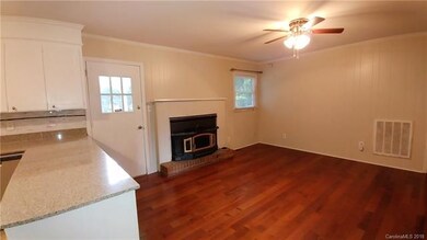 Family room has wood burning fireplace insert and 