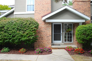 Entrance to property with brick siding and covered front porch