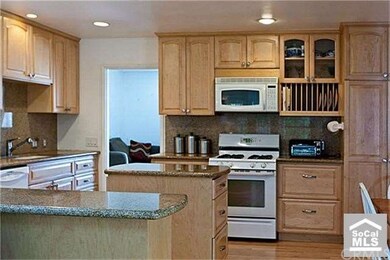 Remodeled kitchen with real wood cabinets and gran