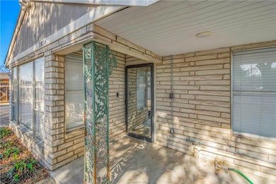 Entrance to property featuring brick siding