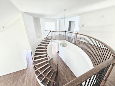 Staircase featuring wood finished floors