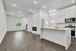 Large open concept with electric fireplace.