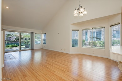 Unfurnished living room featuring high vaulted cei