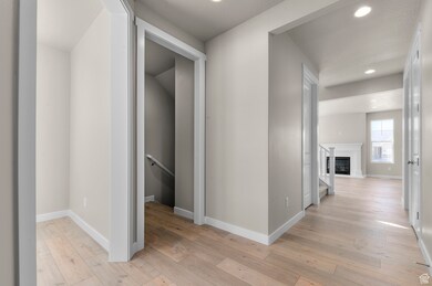 Hall featuring light wood-type flooring and recessed lighting