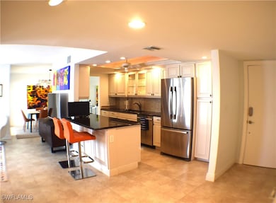 Kitchen featuring a peninsula and open to the livi