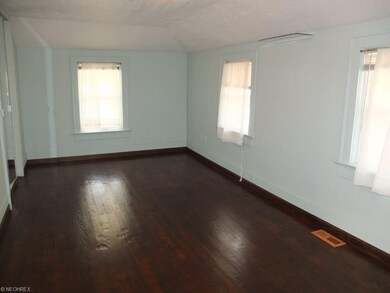 Bedroom 1 with hardwood floor.